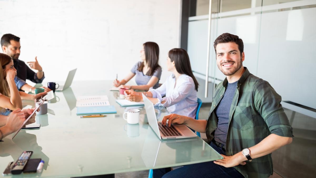 portrait-hispanic-young-man-sitting-with-colleagues-meeting-room_30758700