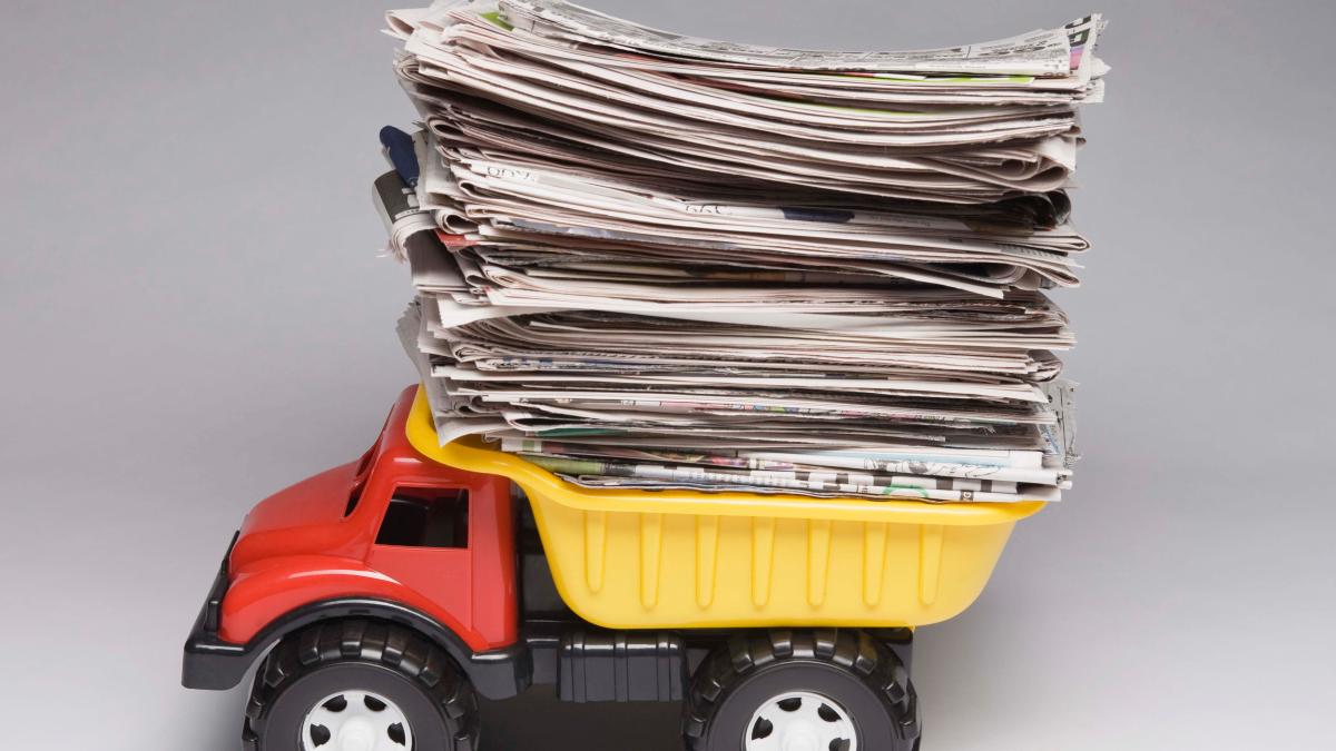 toy-dump-truck-with-stack-of-newspapers-2285980_69697600