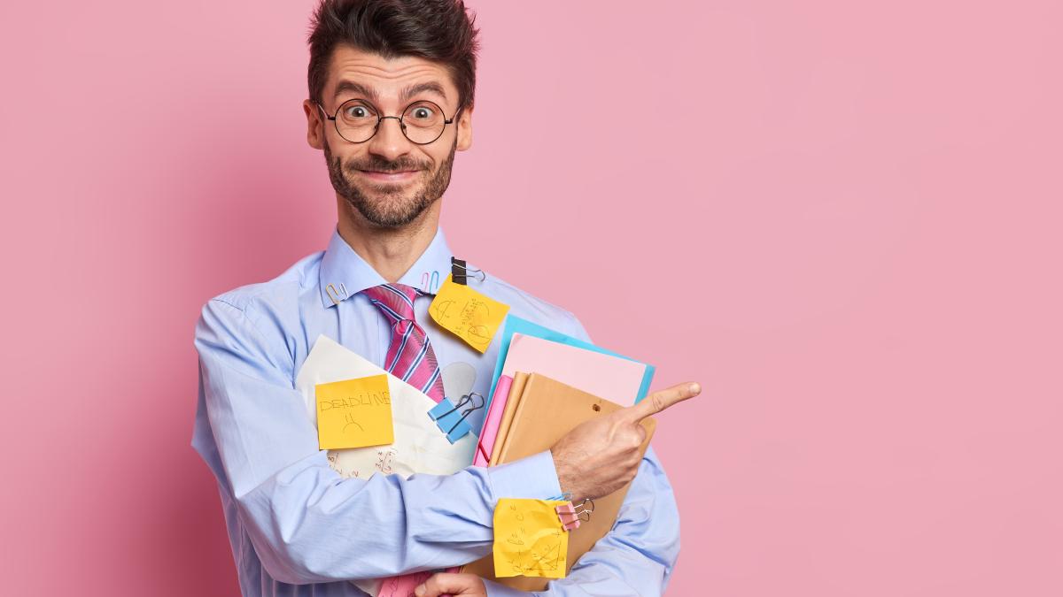 happy-positive-unshaven-man-office-worker-demonstrates-results-his-research-work-stuck-with-stickers-holds-folders-with-documents-indicates-aside-blank-space_51287700