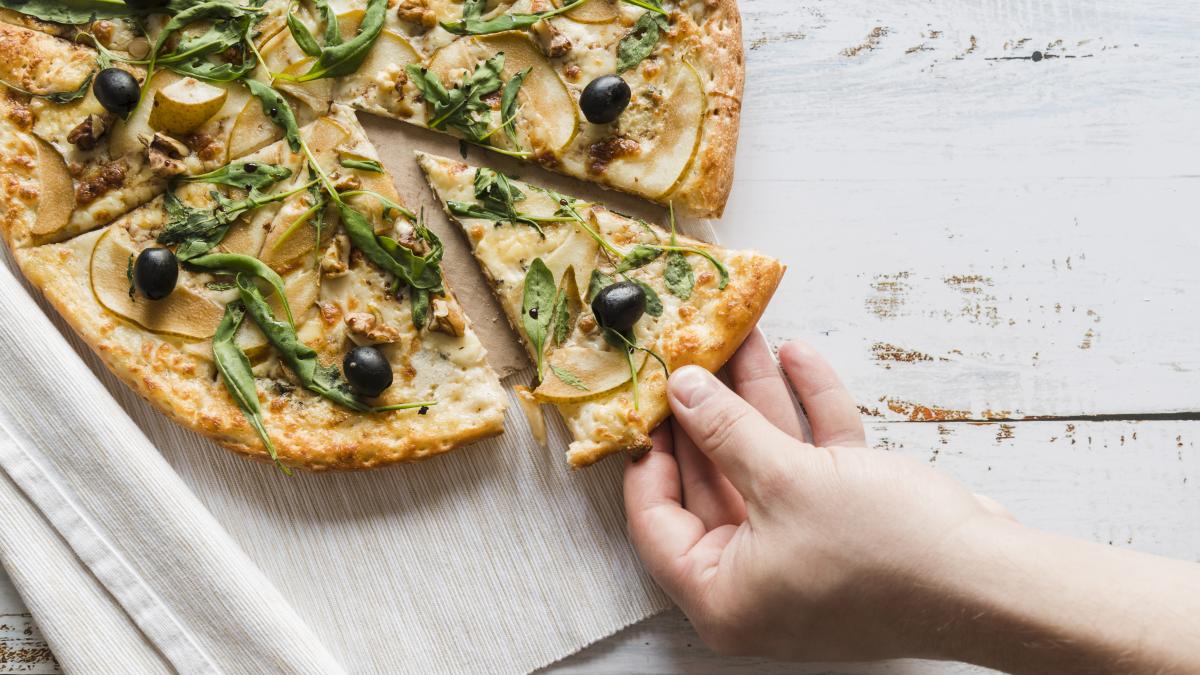 top-view-hand-taking-slice-pizza_76355300