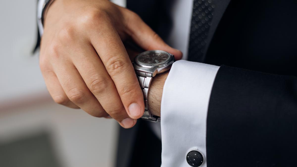 man-is-looking-watch-his-wrist_86287700