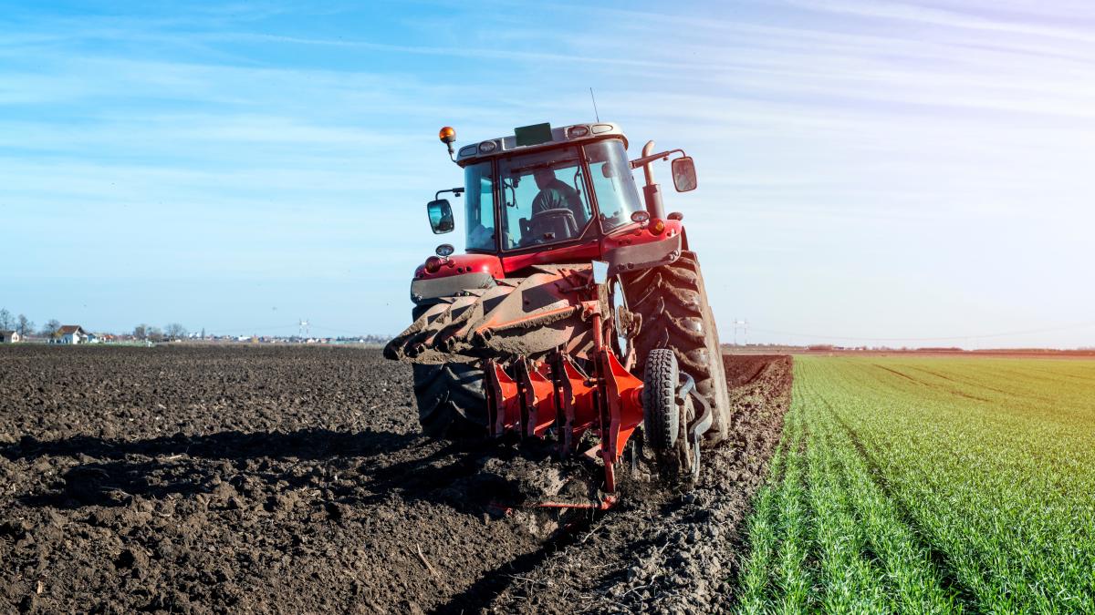 tractor-agricultural-machine-cultivating-field_03858400