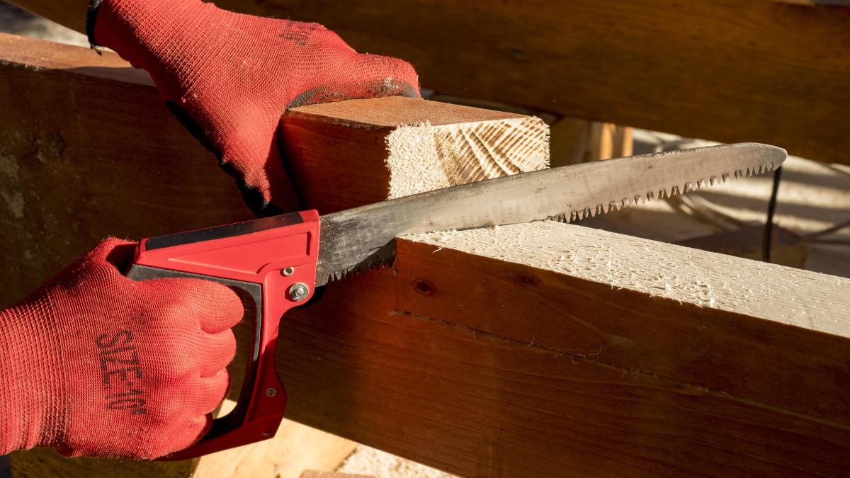 person-wearing-protection-gloves-using-drill_67528000