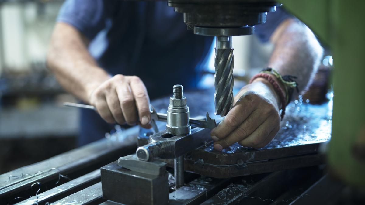 worker-operating-industrial-machine-metal-workshop_48910800