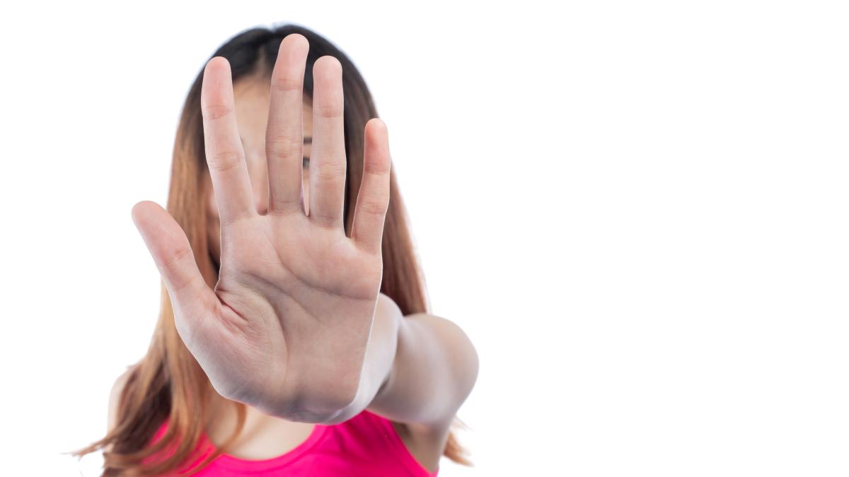 woman-making-stop-gesture-with-her-hand_79035900