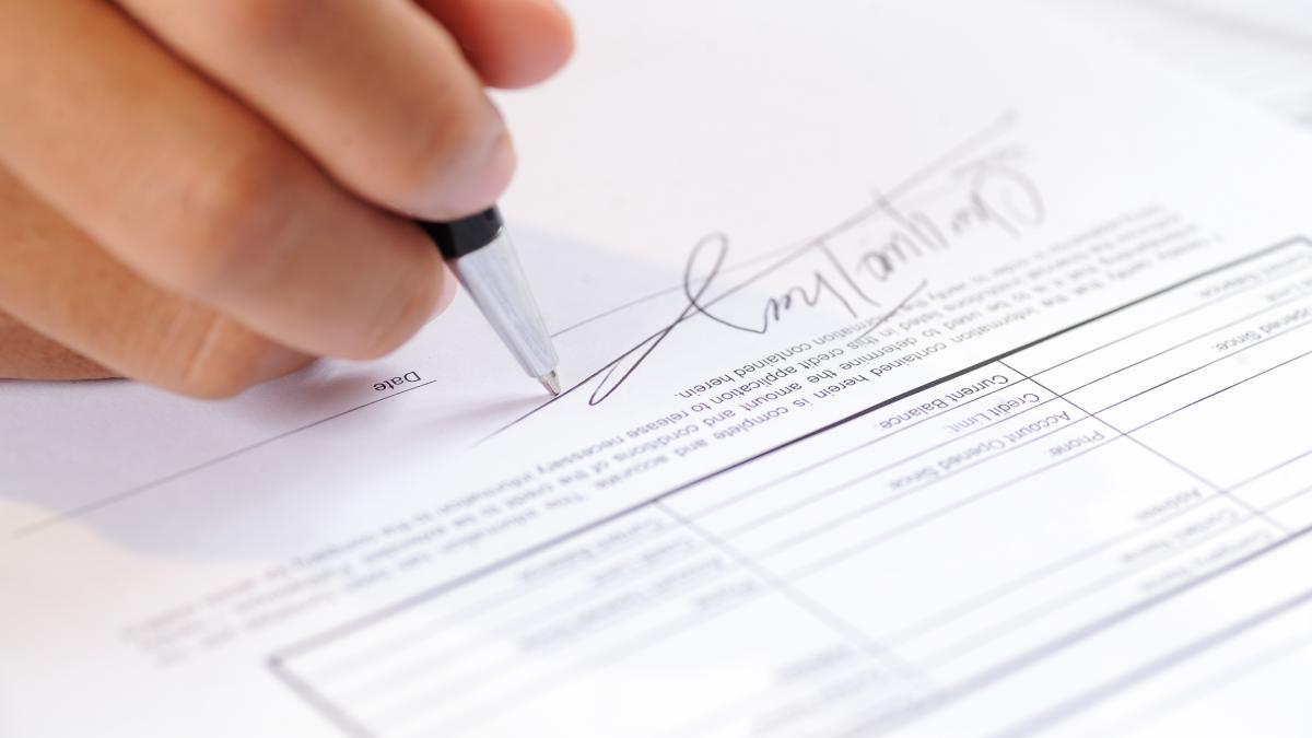 closeup-person-signing-document-with-ball-pen_06290100