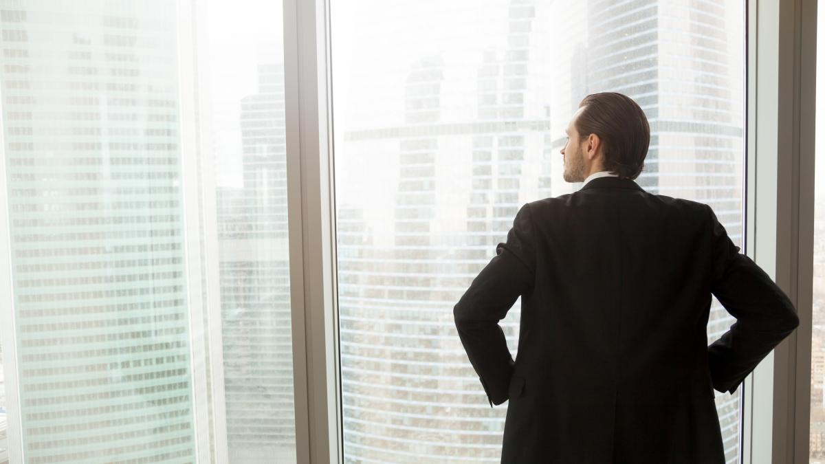 businessman-thinking-about-future-near-window_94643500