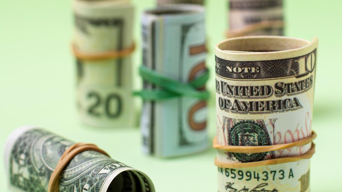 variety-rolled-currency-green-background_38072500