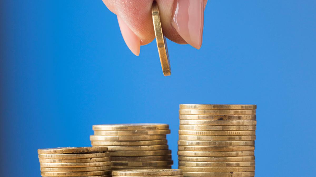 person-placing-coin-pile-coins_29374900