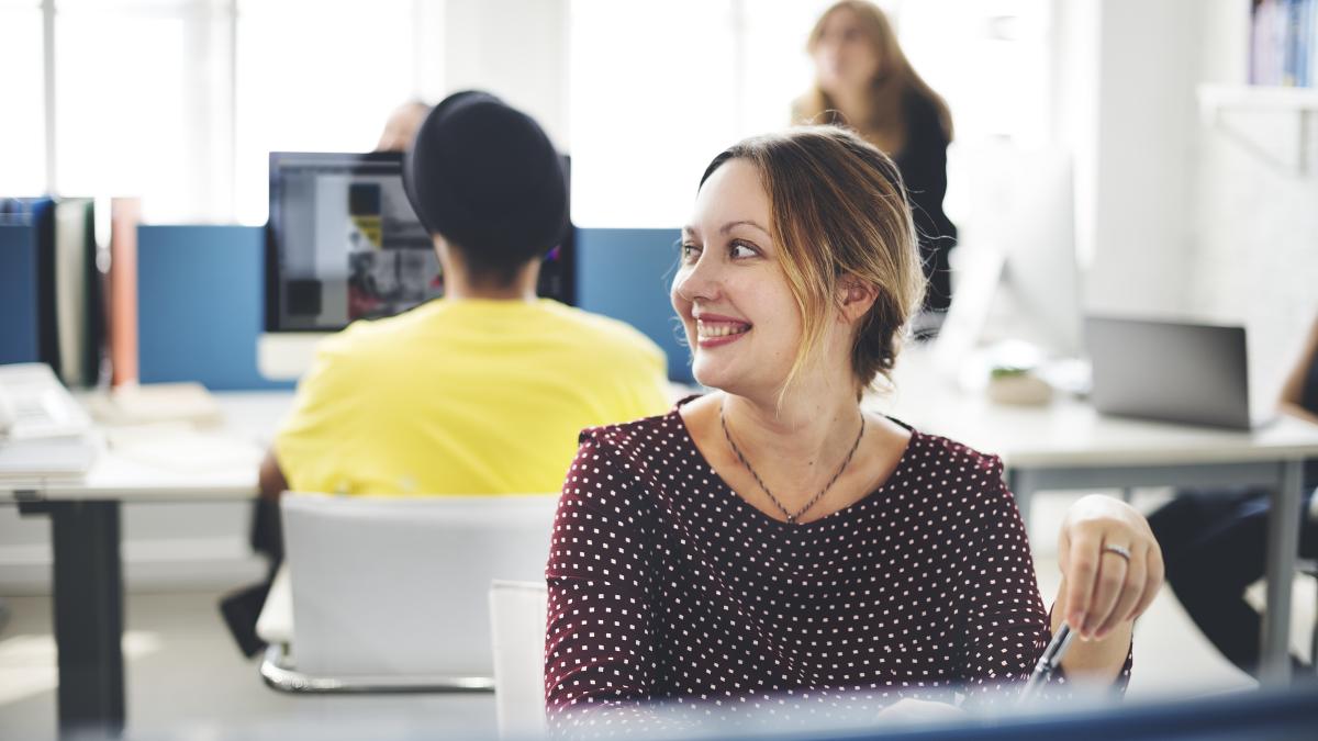 closeup-cheerful-caucasian-woman-working-office_73686600