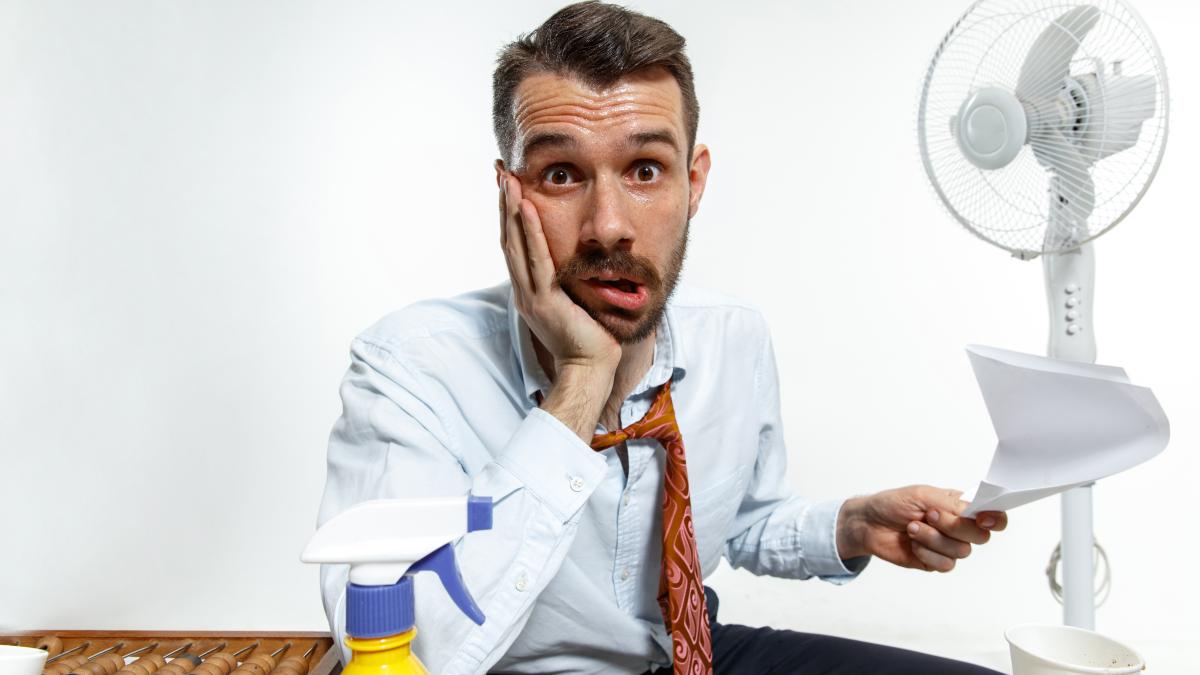 young-man-suffering-from-heat-office_36458200
