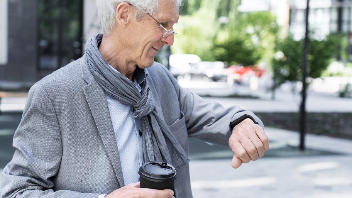 stylish-older-man-city-looking-smartwatch_38771800