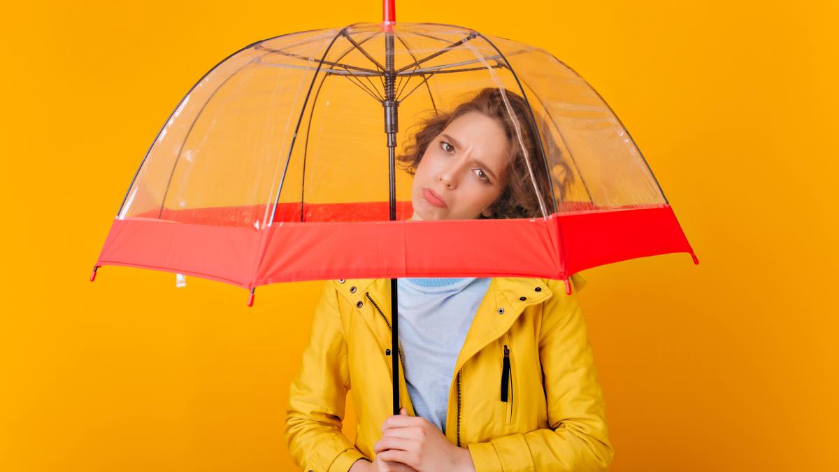 upset-dark-haired-girl-posing-umbrella-portrait-sad-caucasian-lady-raincoat-holding-parasol-bright-wall_58007600