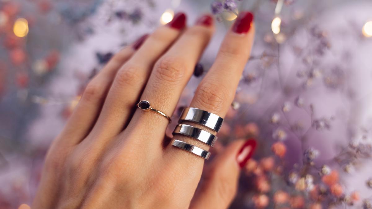 close-shot-woman-hand-fingers-wearing-two-rings_26930900