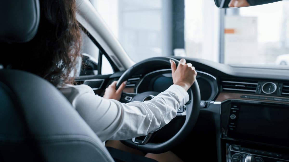 hands-steering-wheel-beautiful-businesswoman-trying-her-new-car-automobile-salon_28212500
