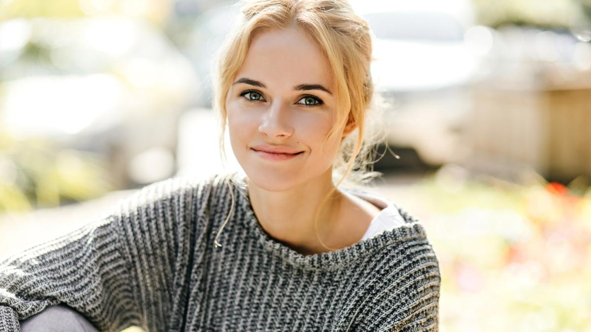 snapshot-curly-blond-girl-with-slight-smile-looking-camera-street_31798000