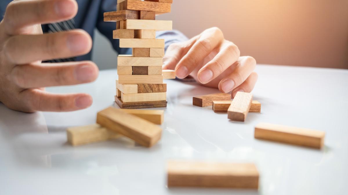 planning-risk-strategy-business-businessman-gambling-placing-wooden-block-tower_64975300
