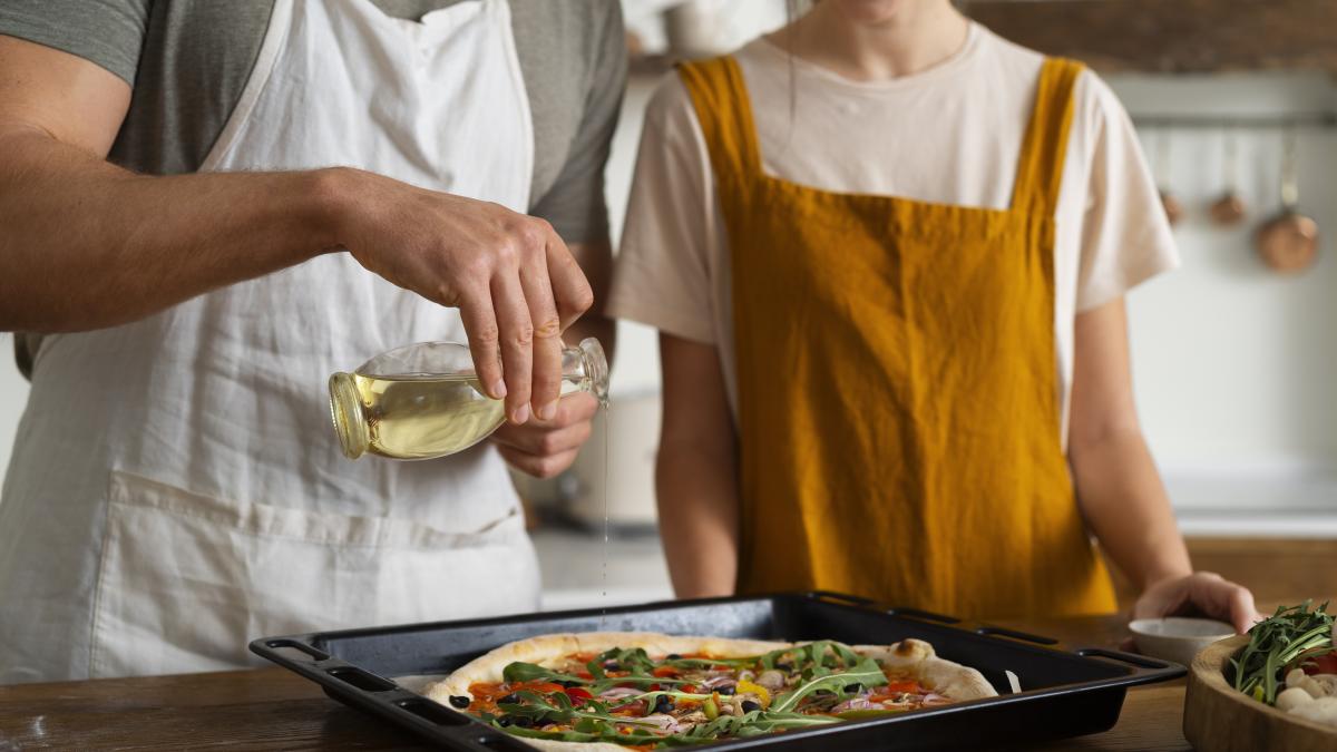 front-view-people-cooking-pizza-kitchen_90906300
