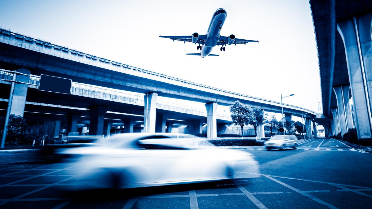 blurred-street-scene-city-with-plane-flying-1_28396100