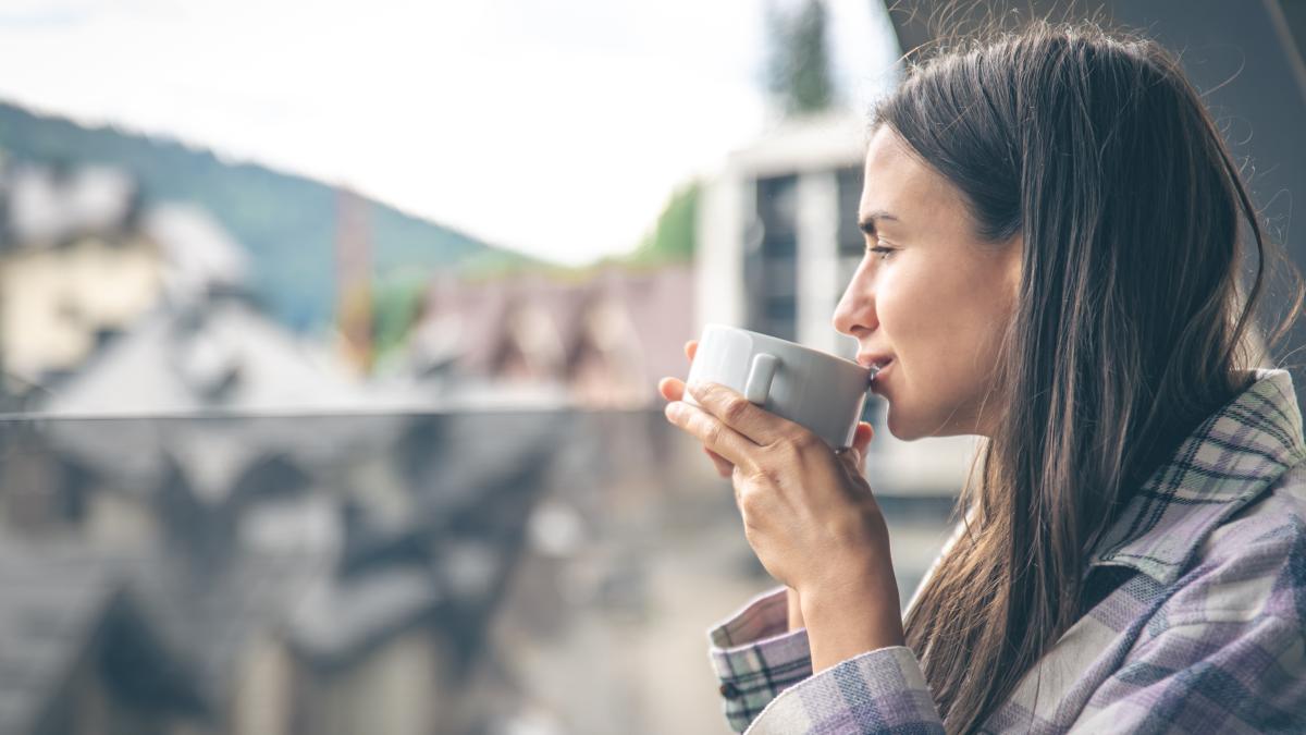woman-drinking-coffee-balcony-morning-1_99604700