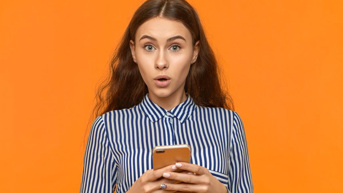 oops-funny-adorable-young-female-raising-eyebrows-opening-mouth_93545800