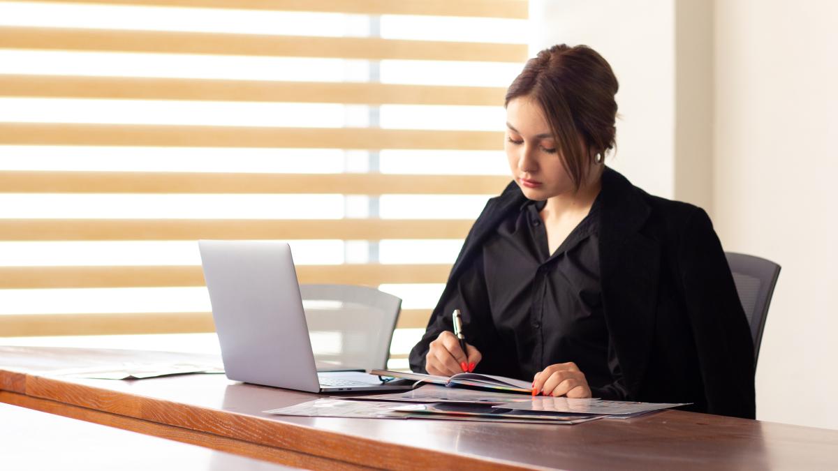 front-view-young-beautiful-businesswoman-black-shirt-black-jacket-using-her-silver-laptop-writing-reading-working-inside-her-office-work-job-building_68839900