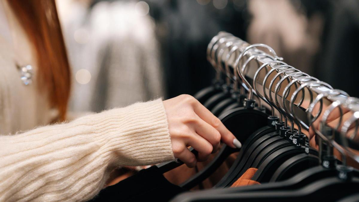 closeup-hands-unrecognizable-female-buyer-choosing-fashion-clothes-rack-clothing-store-selective-focus-closeup-woman-shopaholic-looking-through-racks-finds-appropriate-clothing_21105900