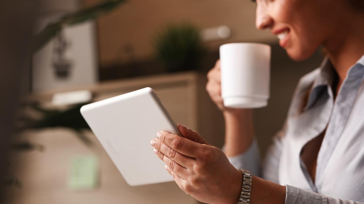 close-up-happy-entrepreneur-enjoying-coffee-break-while-browsing-internet-touchpad_29949200