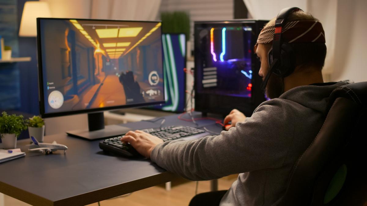 videogamer-winning-first-person-shooter-tournament-using-rgb-keyboard-professional-headphones-pro-player-man-talking-with-other-players-online-game-competition-powerful-computer_90969900