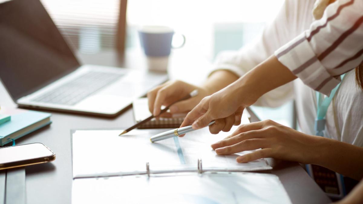 cropped-image-two-businesswomen-discuss-voting-business-strategy-plan-project-pen-pointing-papers_67357500