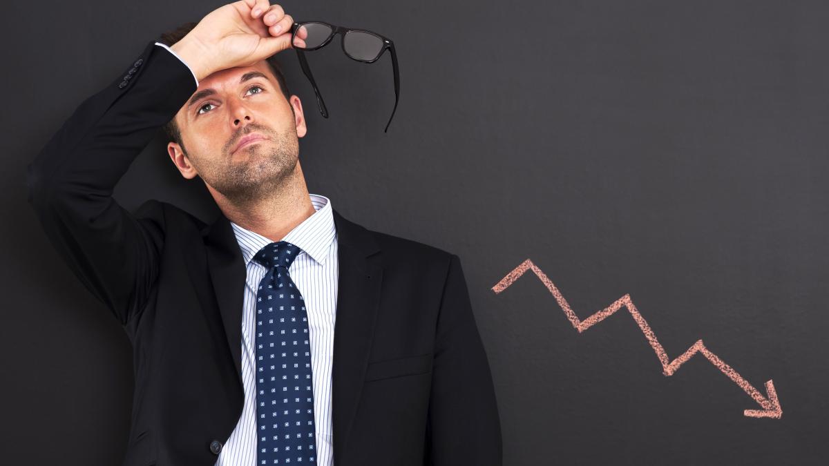 worried-businessman-with-sign-decreased-profit-2_06925400