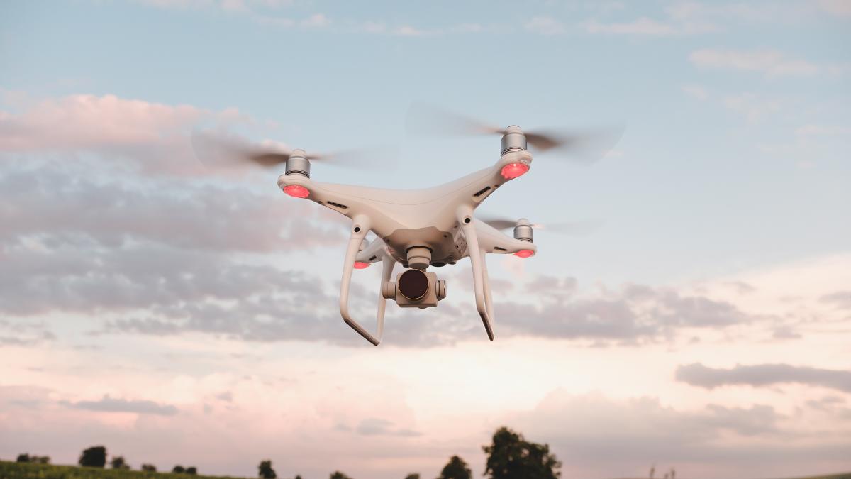 white-drone-hovering-bright-blue-sky_75079300