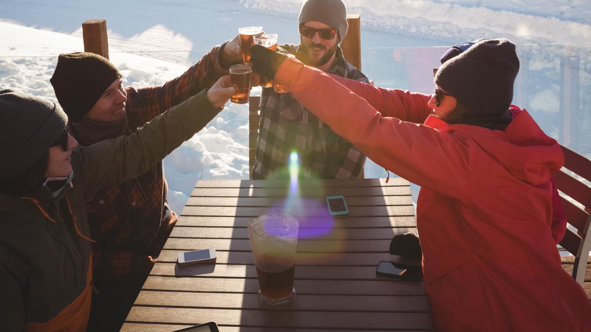 skiers-friends-toasting-glasses-beer-ski-resort_93649700