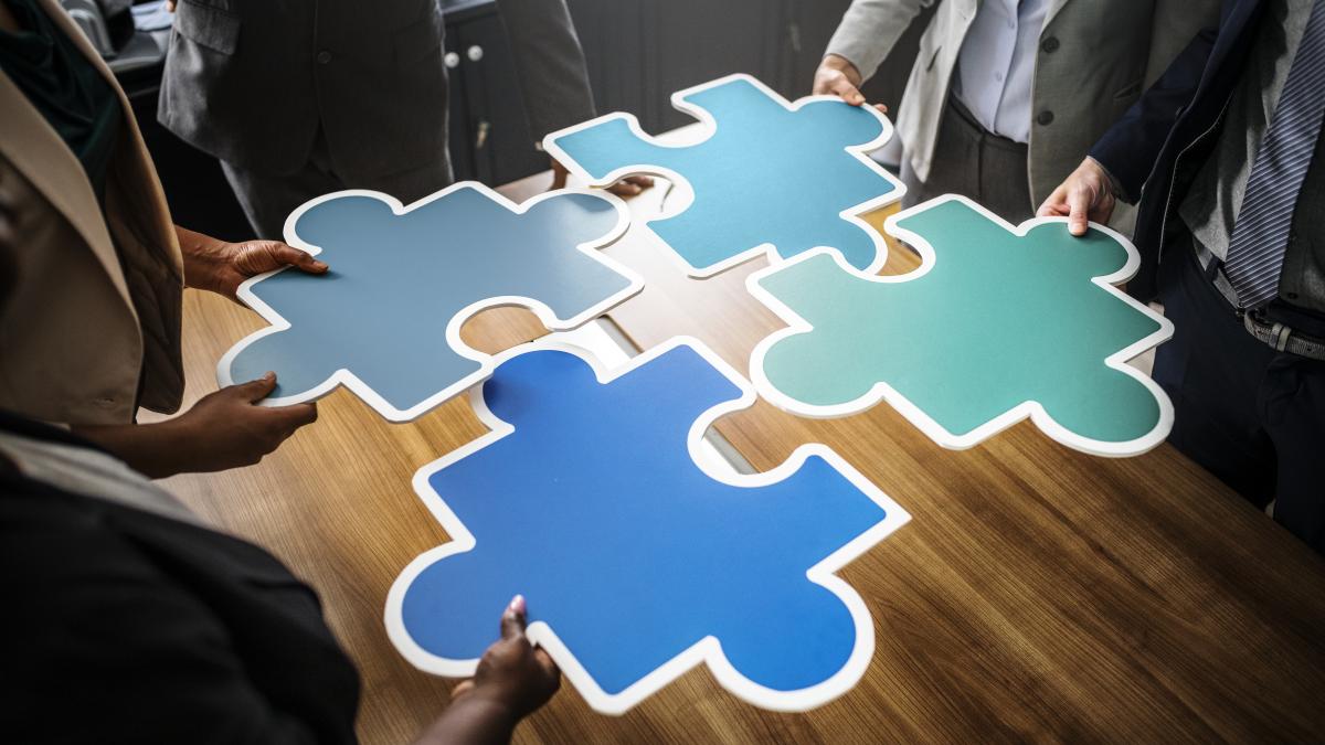 business-people-connecting-puzzle-pieces_92693600