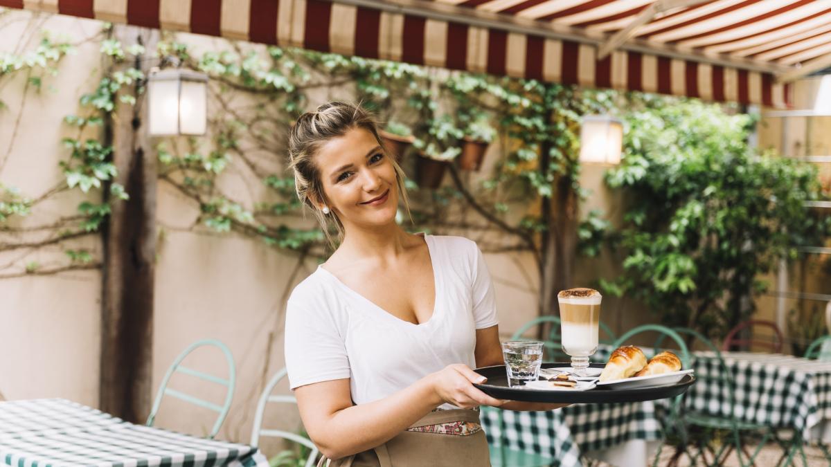 smiling-waitress-holding-tray_29599400