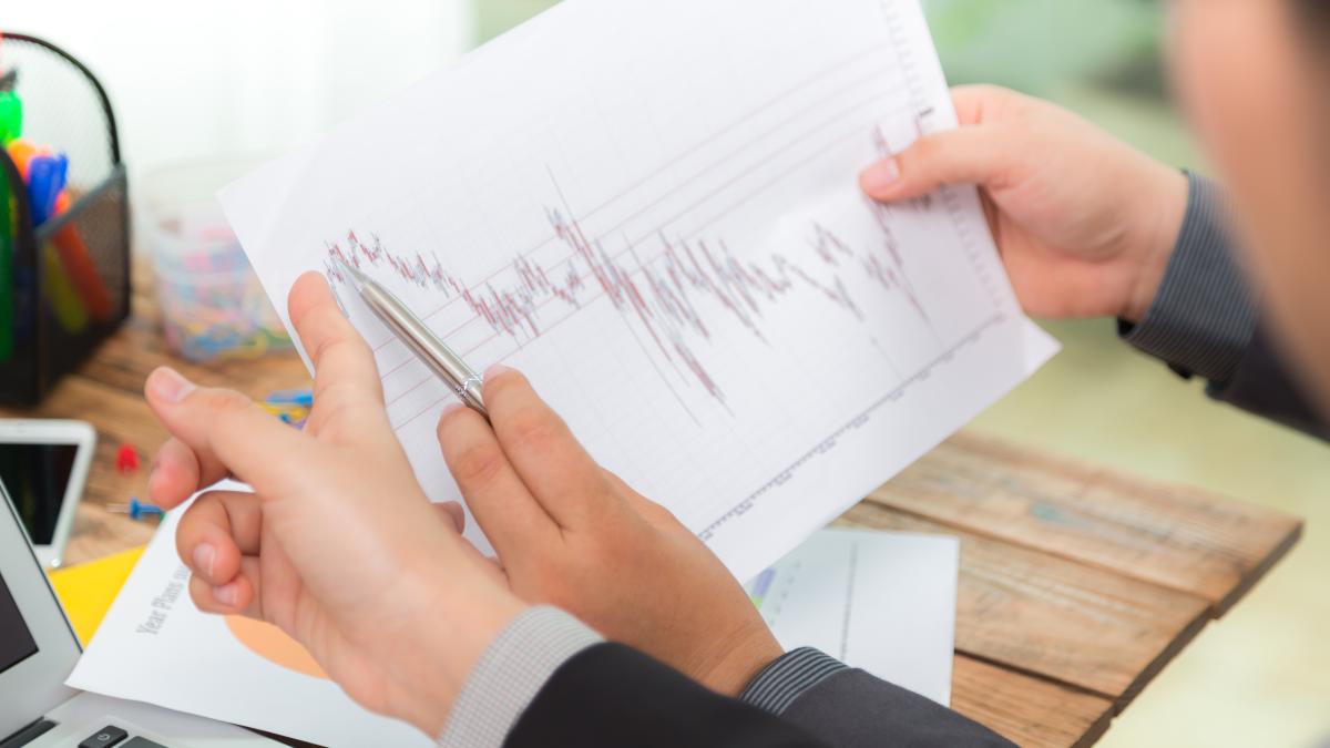 businessman-looking-paper-with-graphs_81194300