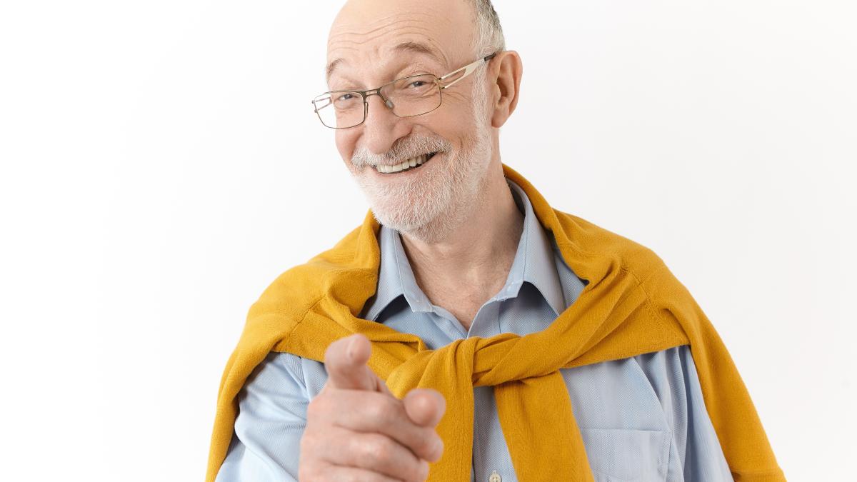 picture-emotional-handsome-senior-man-with-bald-head-gray-stubble-smiling-broadly-pointing-fore-finger-camera-laughing-funny-story-joke-posing-isolated-white-studio-wall-1_39527700