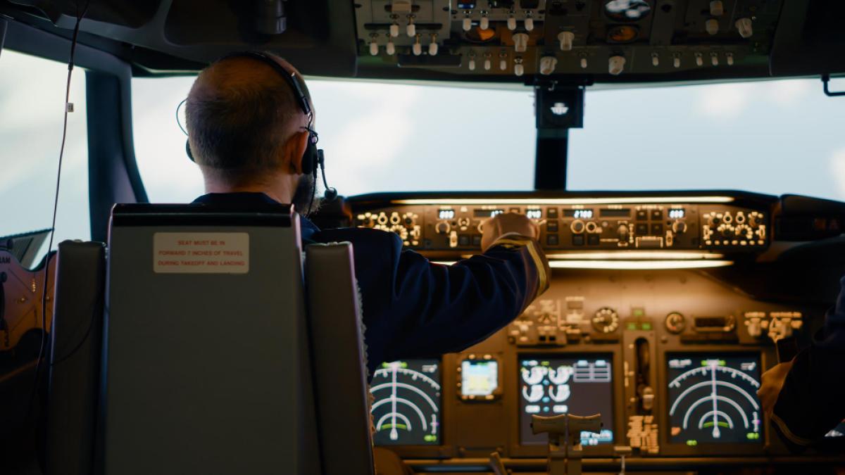 male-airline-captain-fixing-altitude-longitude-buttons-using-dashboard-navigation-command-control-panel-flying-airplane-with-aircrew-radar-compass-power-engine-windscreen_33808700