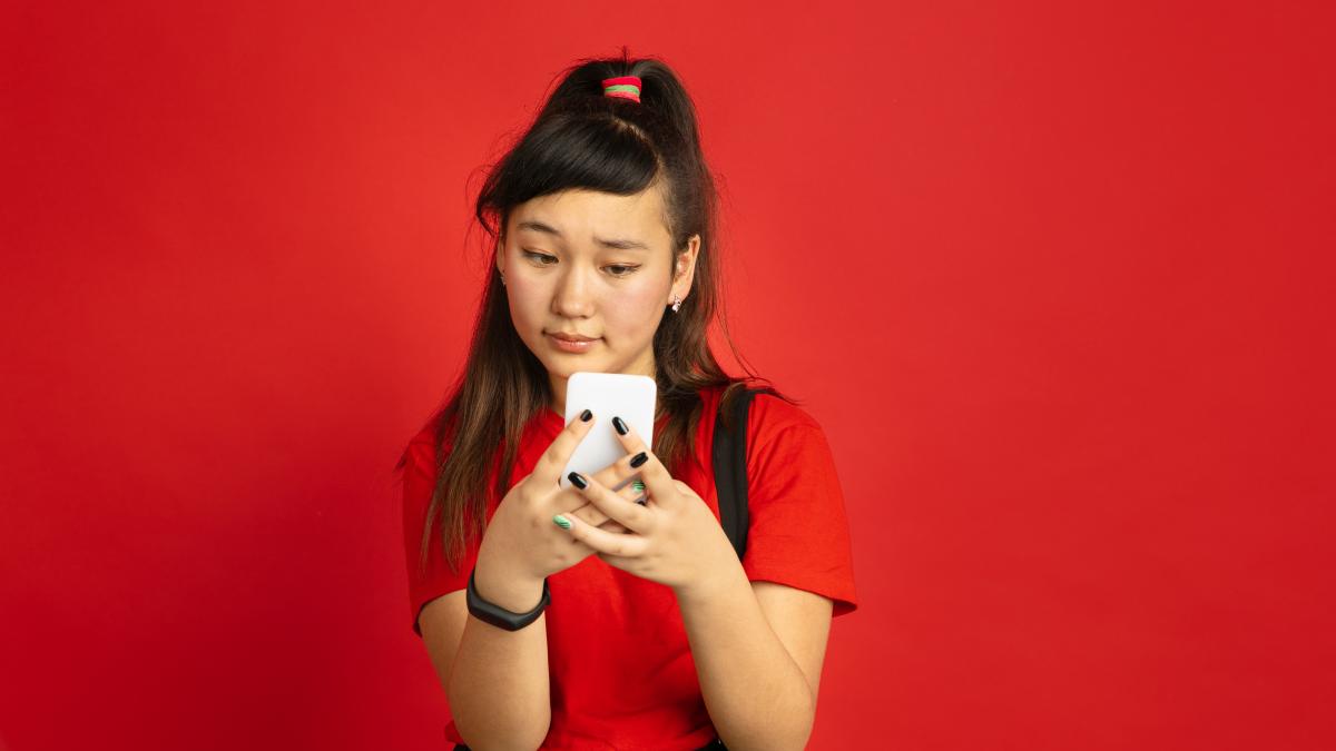 asian-teenager-s-portrait-isolated-red-space_68597800