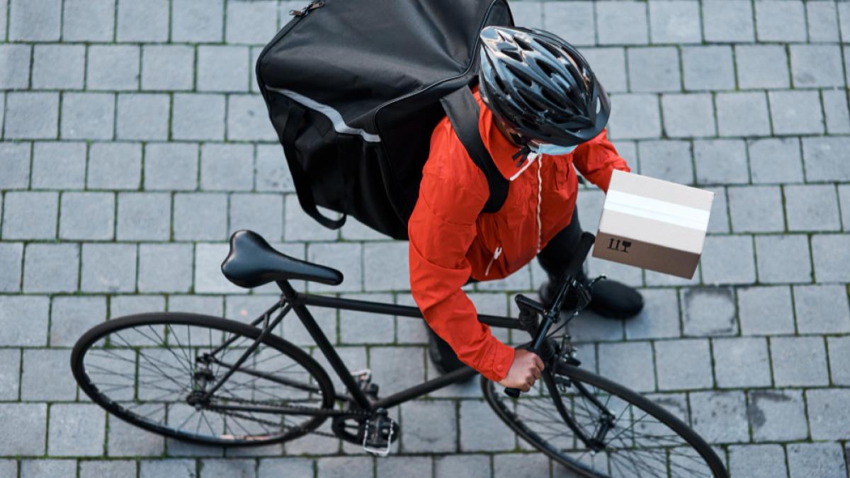 trust-us-deliver-your-goods-time-one-piece-shot-masked-man-out-with-his-bicycle-delivery_62975700