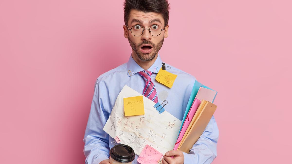 indoor-shot-shocked-skilled-male-student-stares-with-eyes-popped-out-jaw-dropped-works-project-prepares-exams-writes-down-information-papers-remember-drinks-coffee-go_13890300