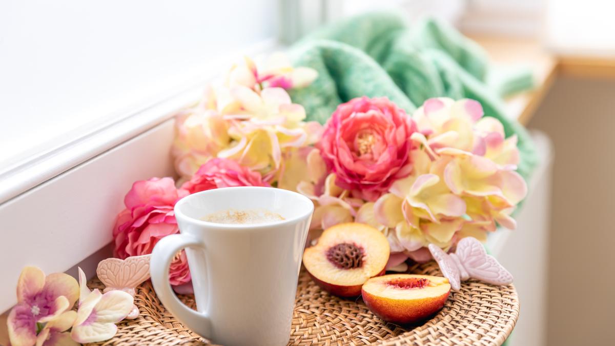 home-composition-with-cup-coffee-flowers-knitted-element_25478200