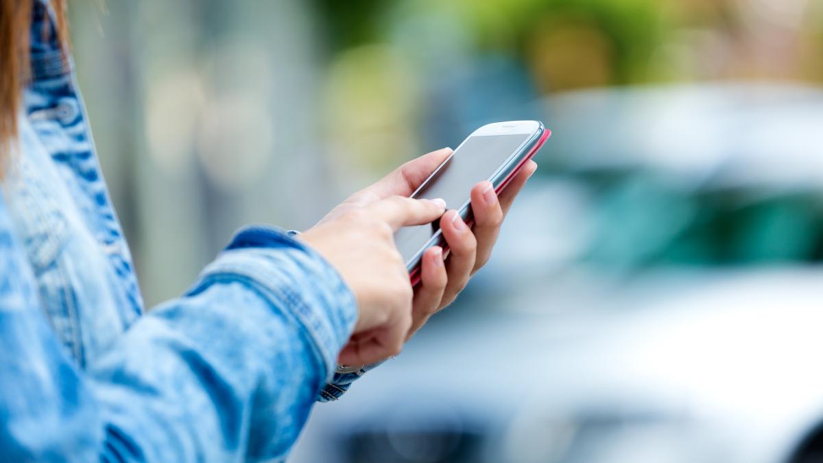 mobile-phone-woman-s-hand-outdoor-image_68469900