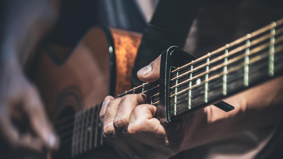 man-plays-acoustic-guitar-closeup_63523800