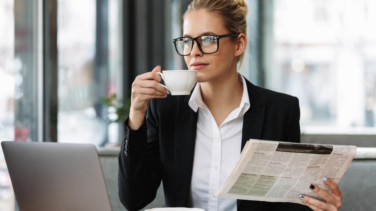 serious-business-woman-reading-newspaper-1_68162300