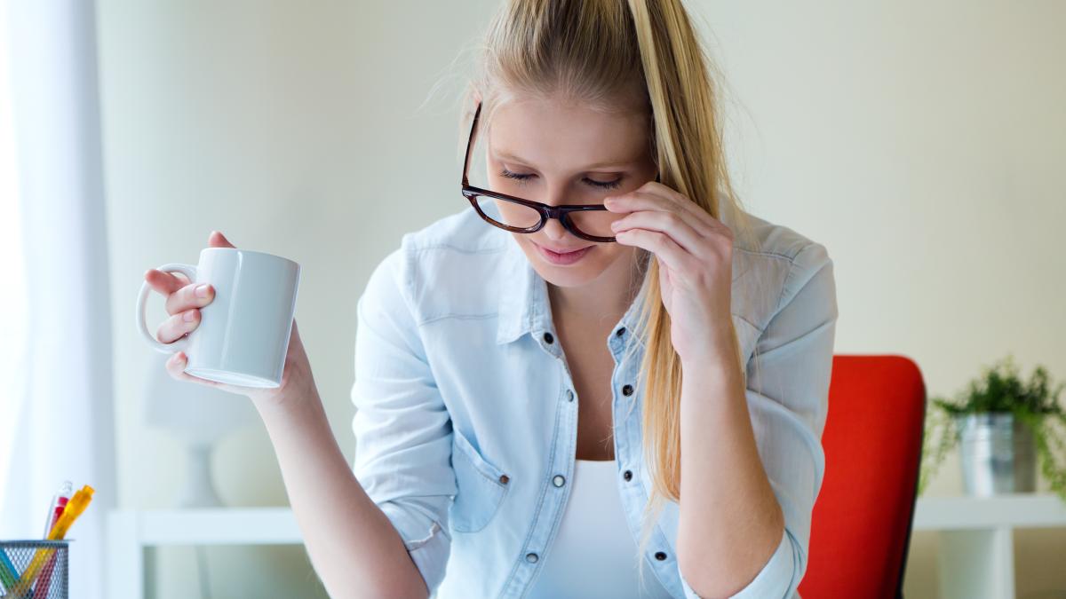 young-beautiful-woman-holding-cup-coffee-reading-newspa_88720900