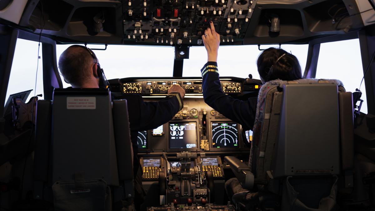 captain-woman-copilot-getting-ready-fly-airplane-takeoff-with-dashboard-navigation-cockpit-command-airline-crew-fixing-altitude-level-with-control-panel-buttons-flying-plane_09679800