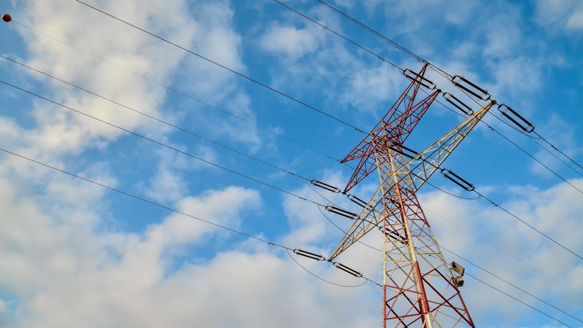 low-angle-shot-high-transmission-tower-with-cloudy-blue-sky_60544200