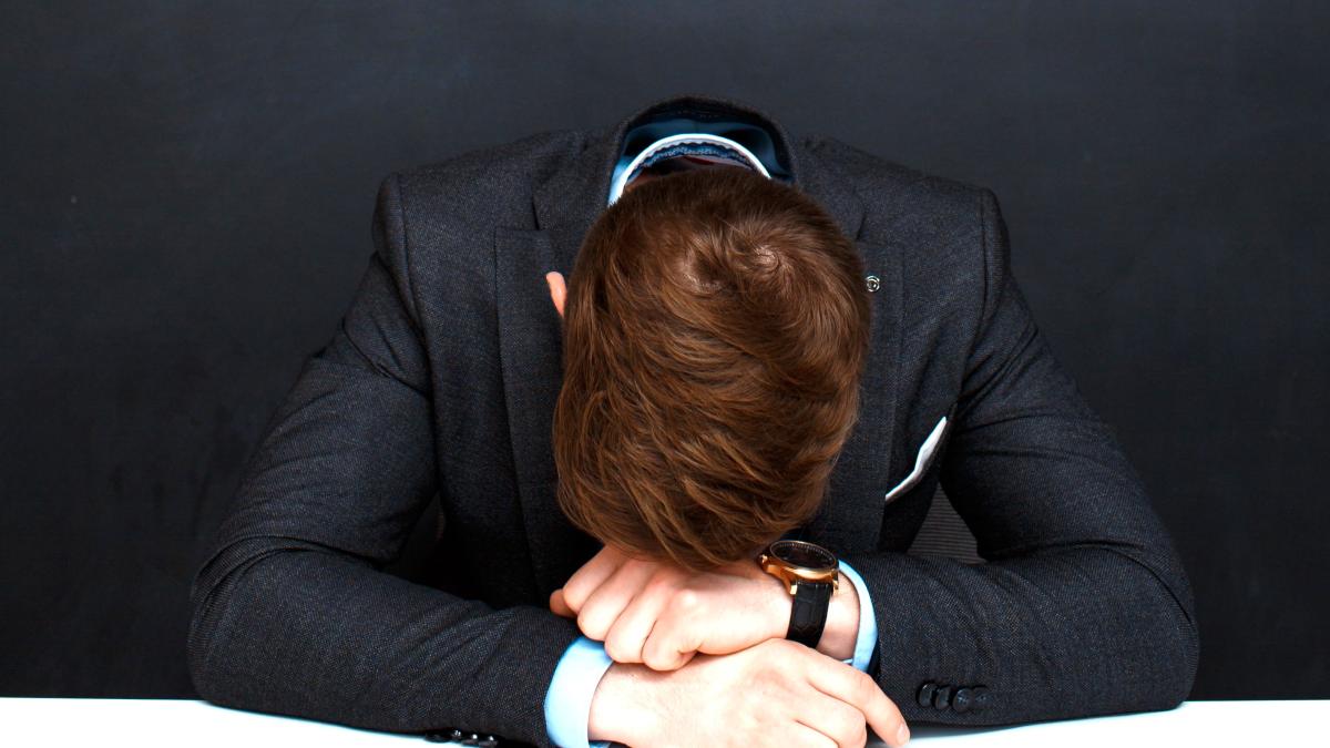 picture-tired-man-blackboard-with-crisis-inscription_82925300