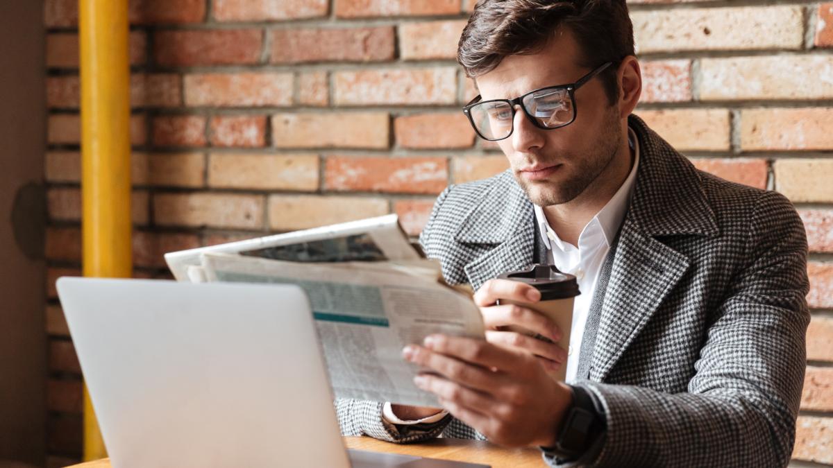 serious-businessman-eyeglasses-sitting-by-table-1_41987400